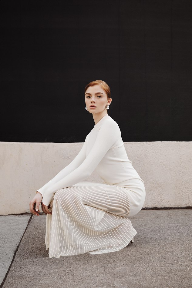 Camryn seated in a flowing white gown