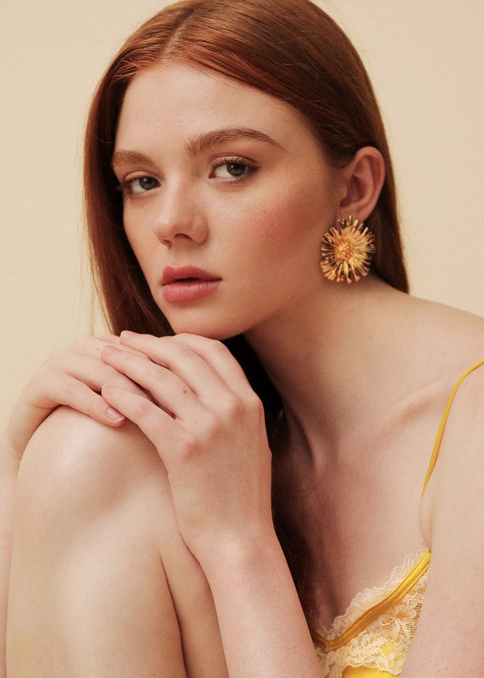 Close beauty portrait in gold-toned silk